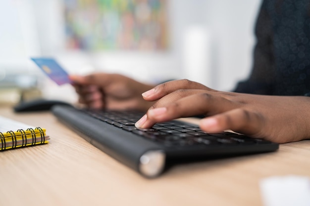 Black keyboard from computer desk in office secretary female employee tapping fingers on keys