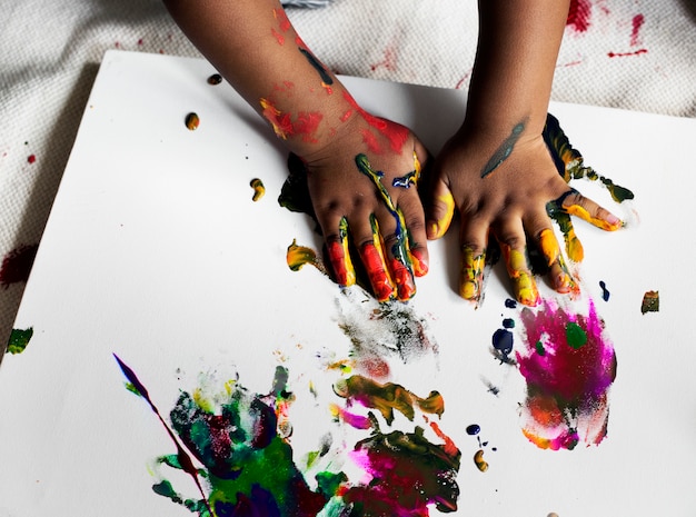 Black kid enjoying his painting