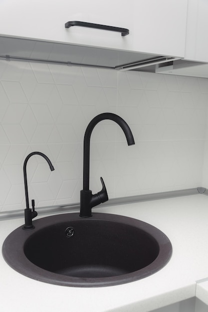 Black kitchen sink with white minimalist backsplash granite countertop gray cabinets and black insulated faucet isolated black sink and faucet black water filtration faucet