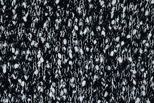 Black knitted knitted background with white spots