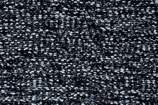 Black knitted knitted background with white spots