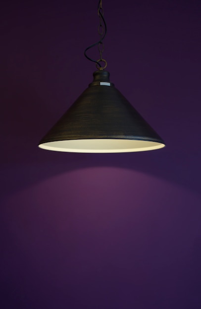 Black lamp on purple wall