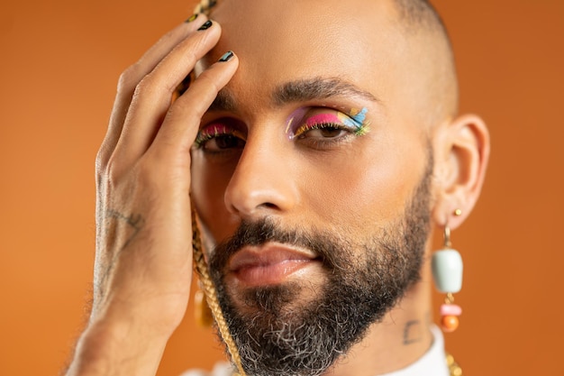 Black latin gay man isolated on pink background