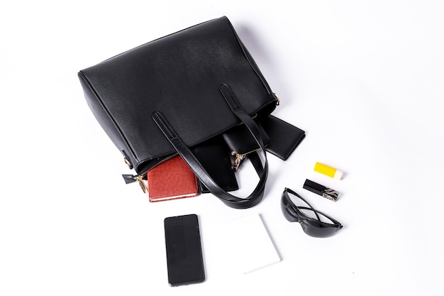 A black leather bag shows what you can hold on a white background