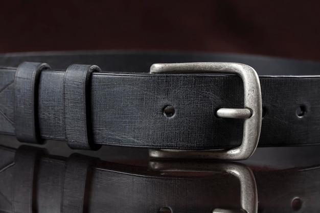 Black leather belt on a dark background Leather products