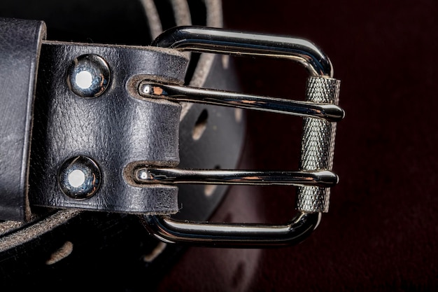 Black leather belt on a dark background Leather products