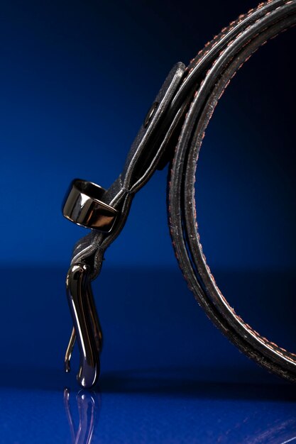 Black leather belt on a dark blue background