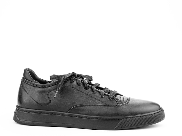 Black leather classic sneakers with laces Casual men's style Black rubber soles Isolated closeup on white background right side view