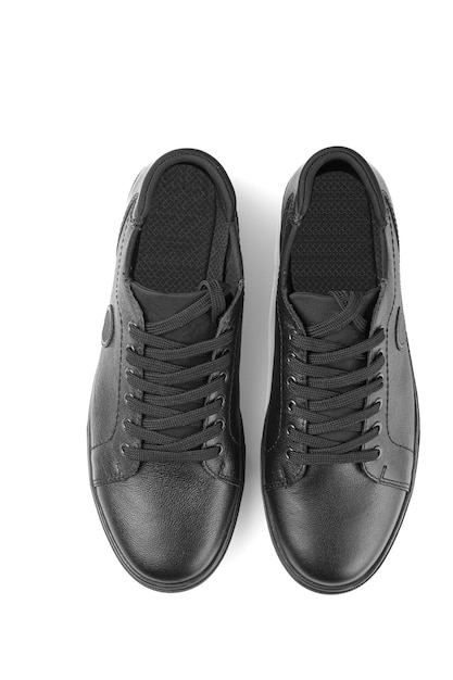 Black leather sneakers on a white background closeup