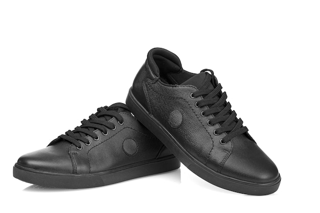 Photo black leather sneakers on a white background