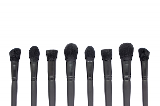 Black makeup brushes isolated on white space