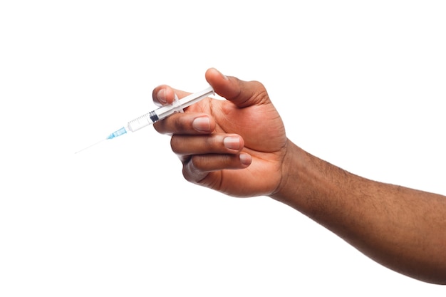 Black male hand holding a plastic syring with liquid for injection isolated on white background. Health care, treatment concept