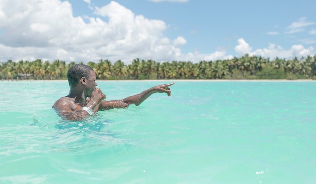 Black male tourist in sea water