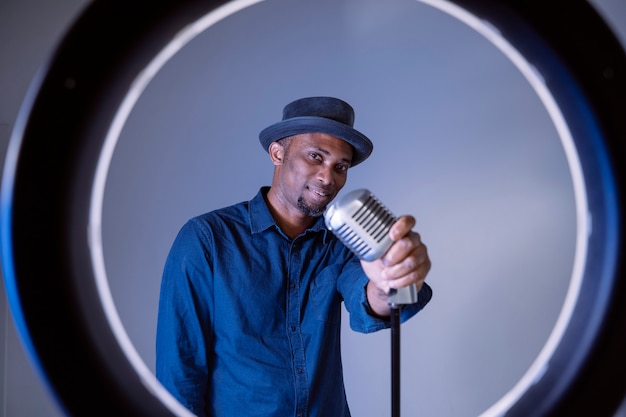 Black man about to sing a vintage song. Isolated male singing ethnic cultural songs.