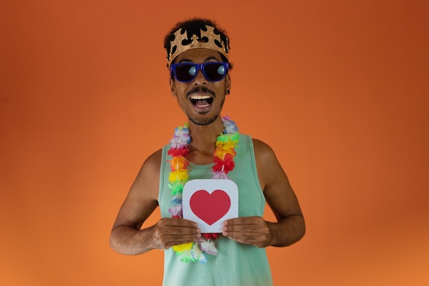 Black man in costume for brazil carnival holding like button isolated on orange background African man in various poses and expressions