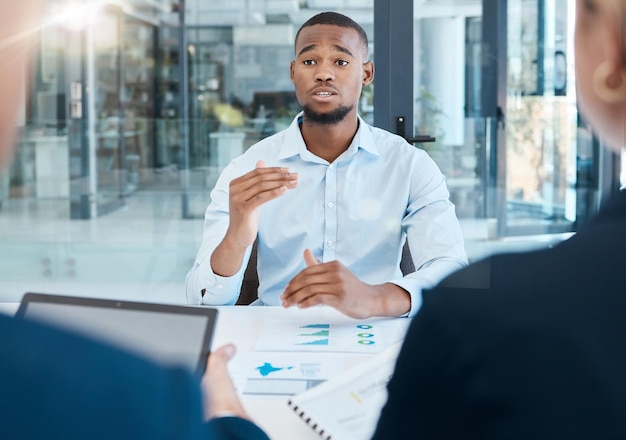 Black man interview and office presentation to business team on analysis data and research African man in corporate discussion explaining company strategy and analytics for innovation and goals