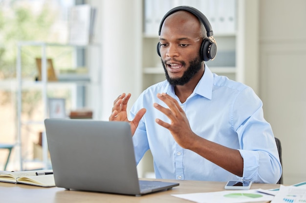 Black man laptop and call center employee talking training and in customer service help and contact us support Crm consulting office worker receptionist or telemarketing communication consultant