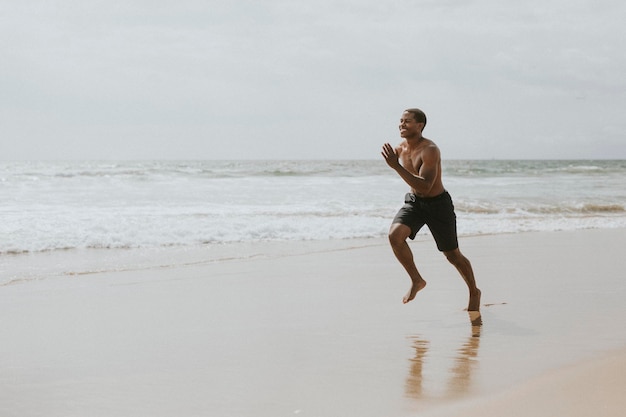 Black man running on the beach