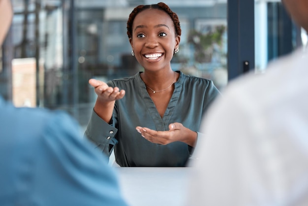 Black manager advisor or coach during business meeting while talking speaking and explaining strategy or vision in office African american woman planning and discussing collaboration with her team