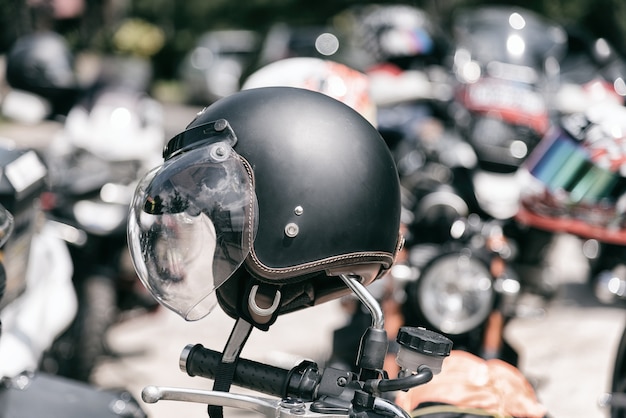 Black matte vintage motorcycle helmet on the motorcycle.