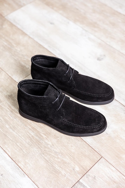 Black men's autumn boots footwear material is genuine leather suede Shoes isolated on the floor