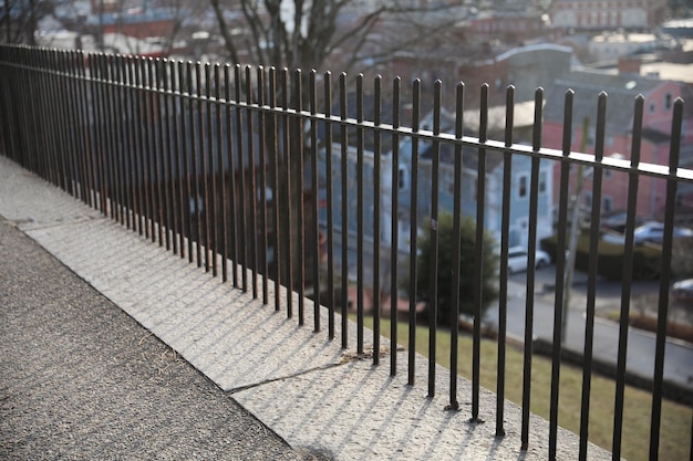 A black metal fence with a red sign on it