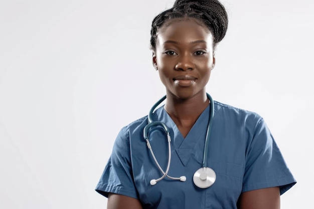 Black nurse in scrubs on white background