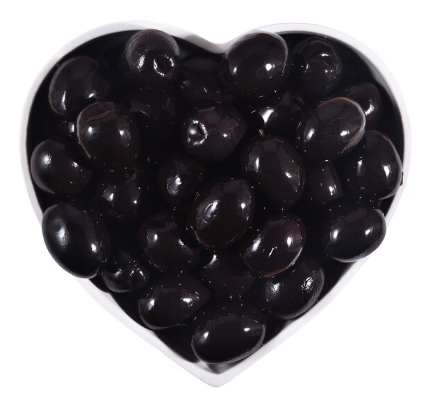 Black olives in plate in the form of heart on a white background