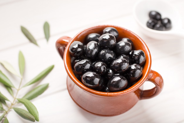 Black olives on rustic bowl