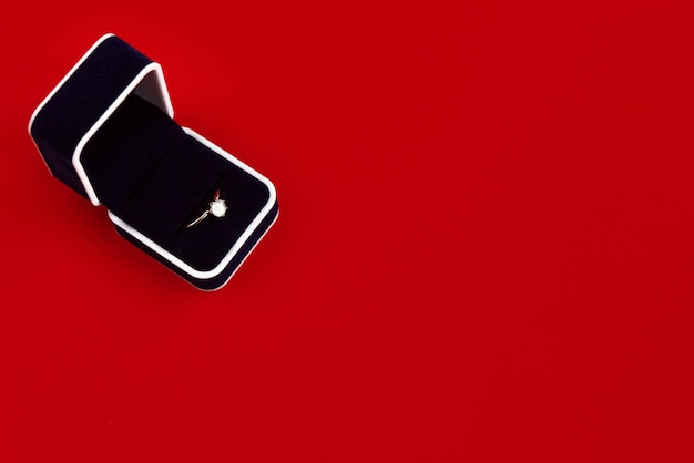 Black order ring box on a red table