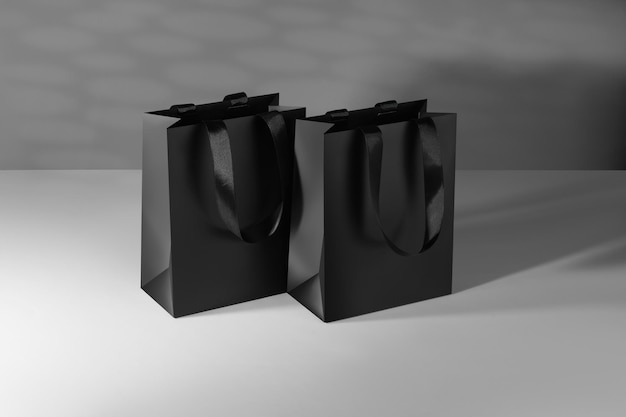 Black paper glossy shopping bag mockup with black handles