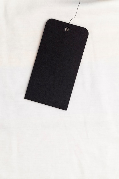 Black paper tag to indicate the price and other information about clothing, black tags on cotton material