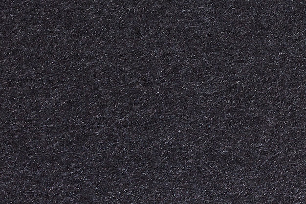 Black paper texture or background. High resolution photo.