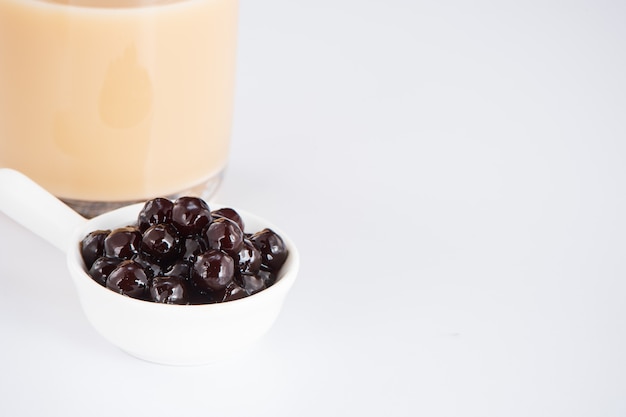 Black pearls. Boiled tapioca pearls for bubble tea on white background. Copy space