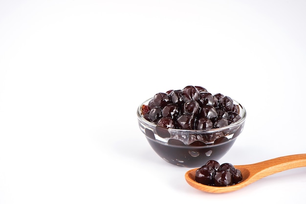 Black pearls. Boiled tapioca pearls for bubble tea on white background. Copy space