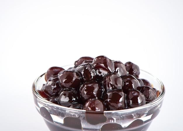 Black pearls. Boiled tapioca pearls for bubble tea on white background. Copy space