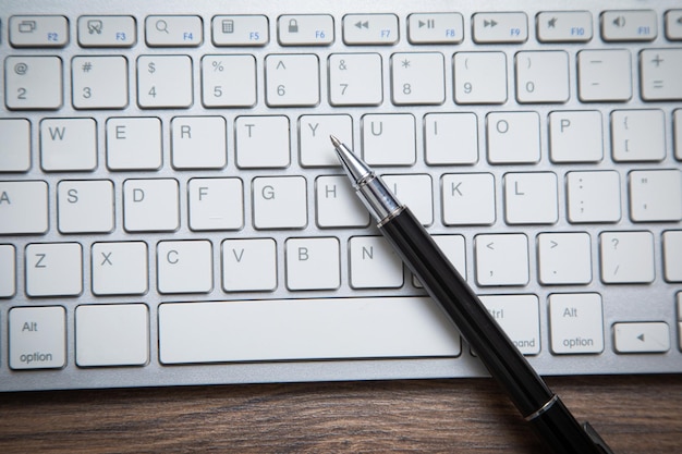 Black pen on the computer keyboard