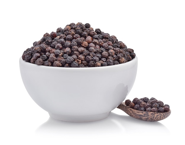 Black pepper in bowl on white background