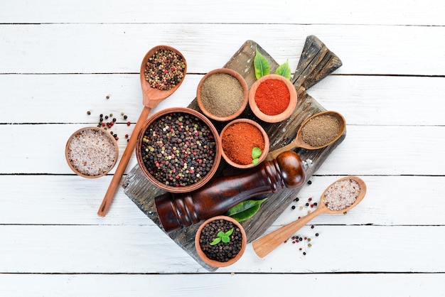 Black pepper colored pepper sea salt ground pepper dried chili pepper Top view On a white background free space for your text