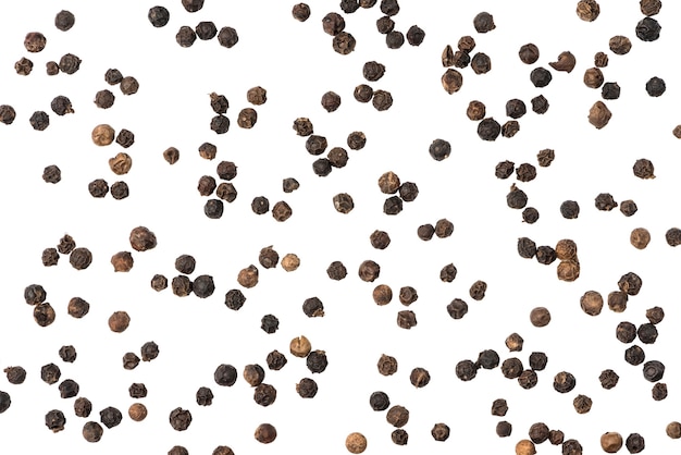 Black pepper seeds on white surface