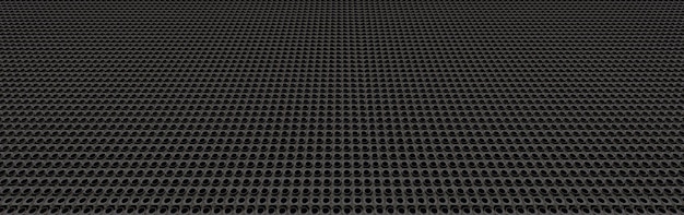 Black perforated metal plate shot in perspective. Metal background close-up