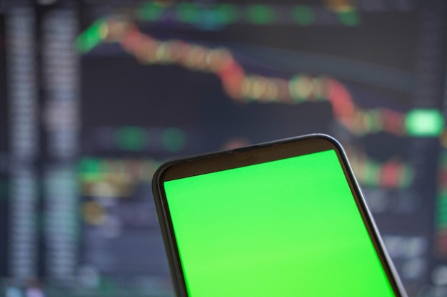 Black phone with blank mockup screen on rising stock graph Closeup hand showing smartphone isolated green display Online banking Fund App use Financial analyst on Invest Market Bank collapse 2023