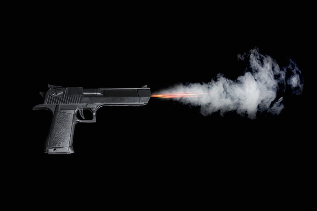 Photo black pistol shooting with fire and smoke on dark background.