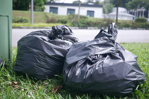 Black plastic Bag with garbage and rubbish bin