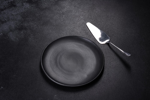 Black plate on a black background Flat lay top view copy space