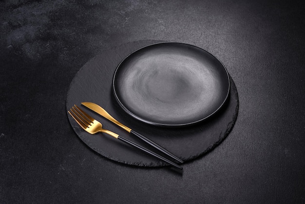 Black plate on a black background Flat lay top view copy space