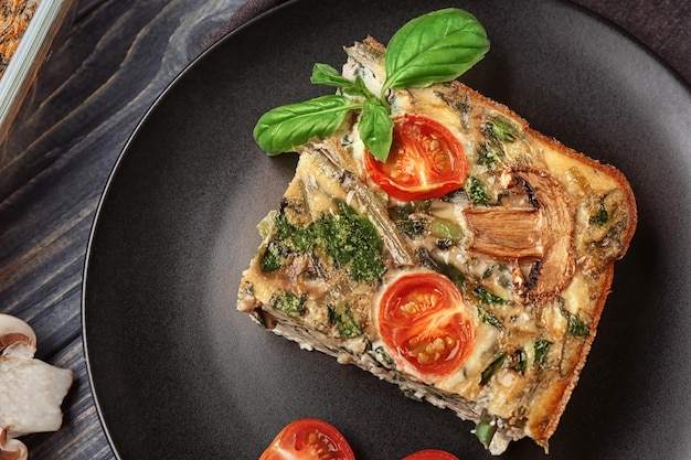 Black plate with delicious spinach frittata