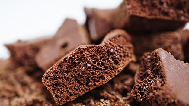 Black porous chocolate pieces close-up