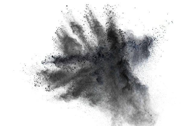 Black powder explosion against white background.The particles of charcoal splattered on white background.