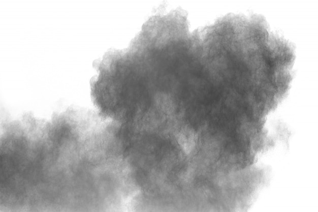 Photo black powder explosion on white background. black dust particles splash.